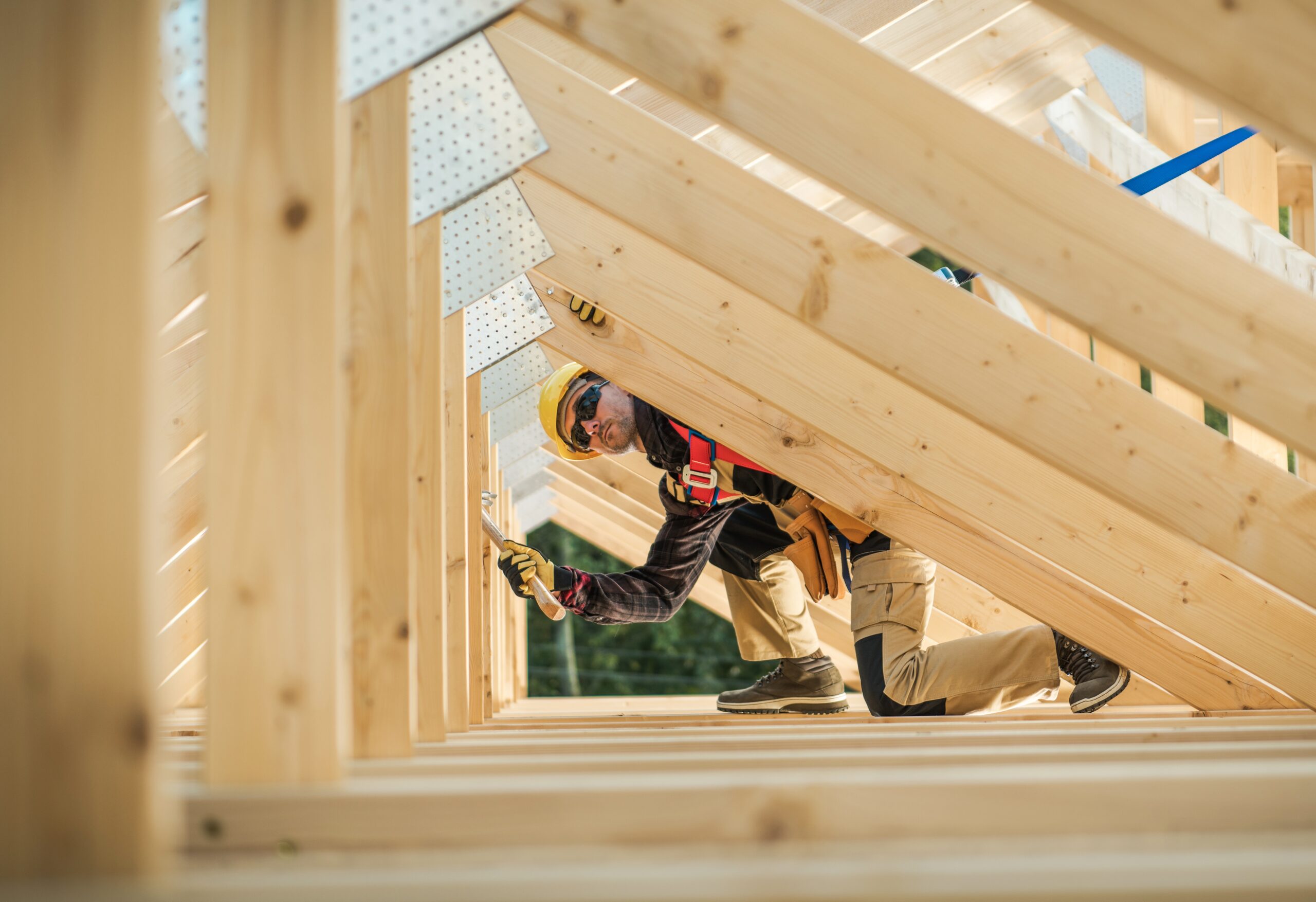 Wooden House Roof Beams Assembly by Construction Worker